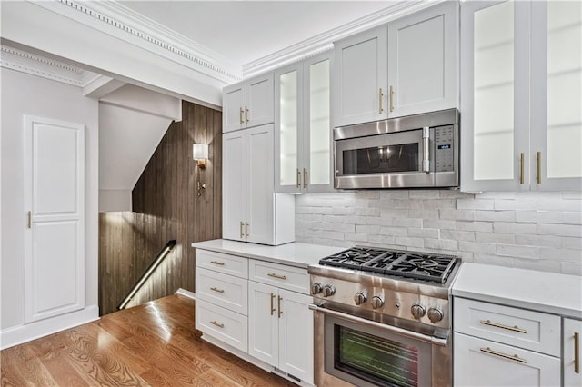 53 Paces W Dr NW, Atlanta, GA 30327 - kitchen with backsplash, light countertops, glass insert cabinets, and stainless steel appliances