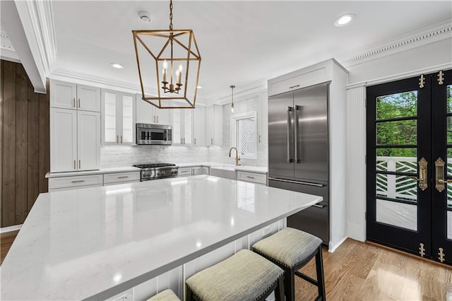 53 Paces W Dr NW, Atlanta, GA 30327 - kitchen with light wood-style flooring, crown molding, and stainless steel appliances