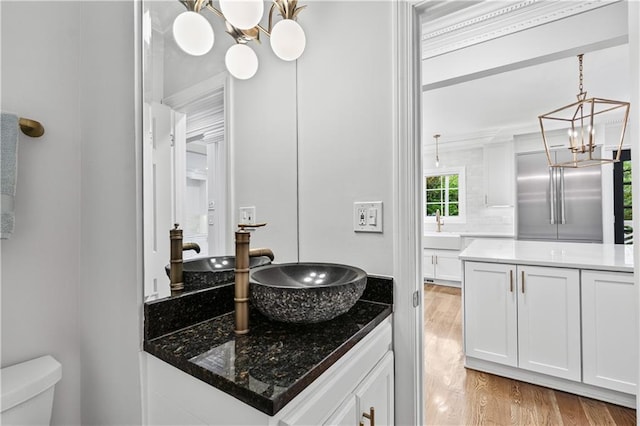 53 Paces W Dr NW, Atlanta, GA 30327 - bathroom with a chandelier, vanity, toilet, and wood finished floors