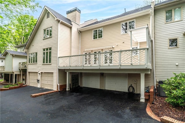 53 Paces W Dr NW, Atlanta, GA 30327 - rear view of house featuring an attached garage and driveway
