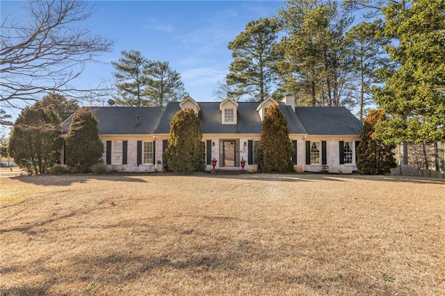 cape cod-style house with a front lawn