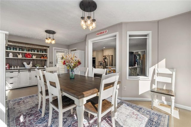 tiled dining room featuring an inviting chandelier