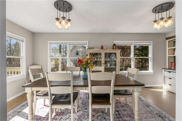 tiled dining space featuring a notable chandelier