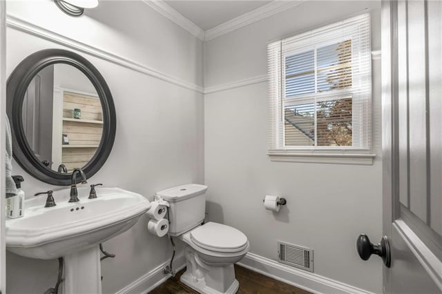 bathroom with sink, wood-type flooring, ornamental molding, and toilet