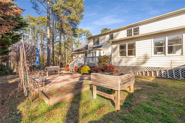 rear view of house with a patio area, a deck, and a lawn