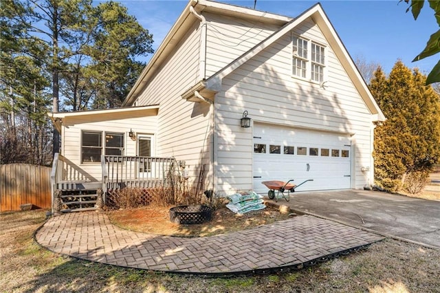 back of property with a garage and a fire pit