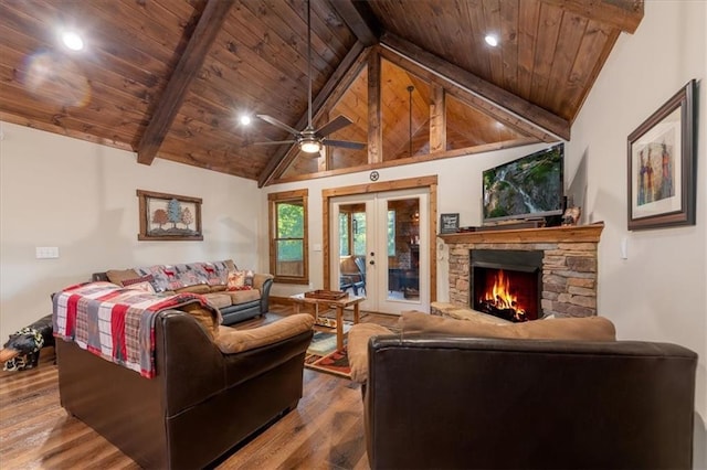 living room featuring wood ceiling, wood-type flooring, a stone fireplace, french doors, and beam ceiling