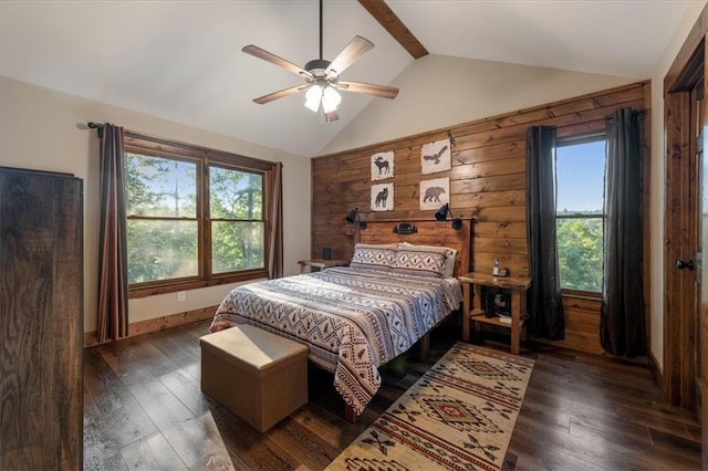 bedroom with ceiling fan, wood walls, dark wood-type flooring, and multiple windows