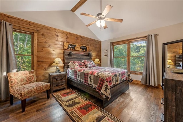 bedroom with ceiling fan, dark hardwood / wood-style floors, wood walls, and lofted ceiling with beams