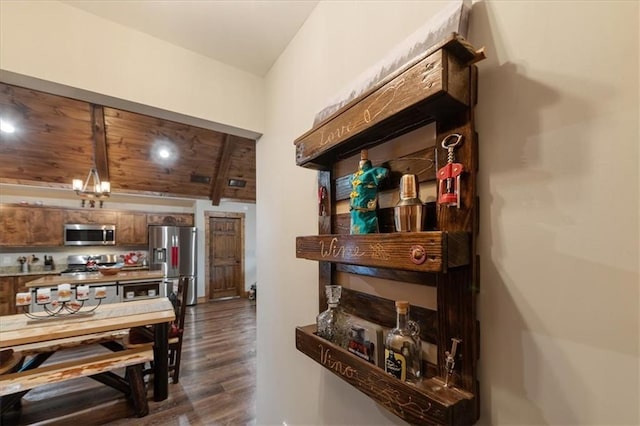 dining space with dark hardwood / wood-style floors and wooden ceiling