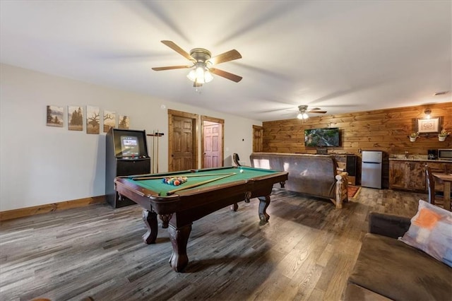 recreation room with ceiling fan, dark wood-type flooring, wooden walls, and billiards