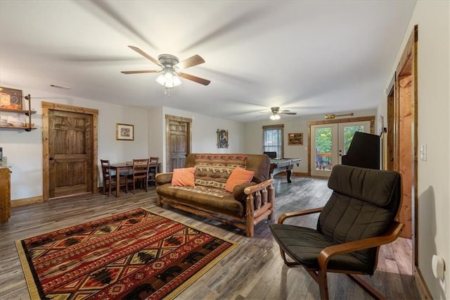 living room with ceiling fan, hardwood / wood-style floors, and french doors