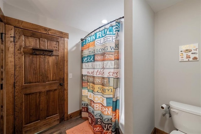 bathroom featuring toilet and walk in shower