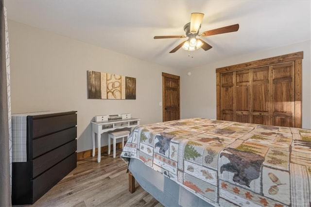 bedroom with ceiling fan, light hardwood / wood-style floors, and a closet