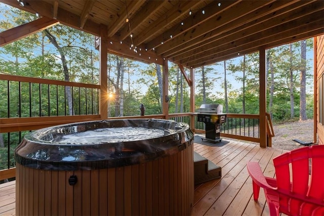 wooden terrace featuring area for grilling and a hot tub