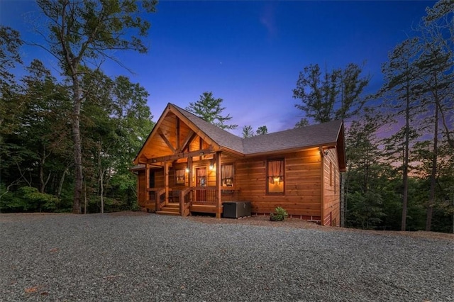 log home featuring covered porch