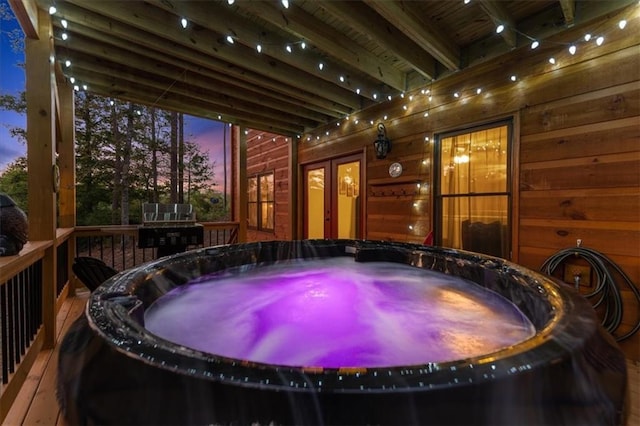 exterior space with a wooden deck and a hot tub