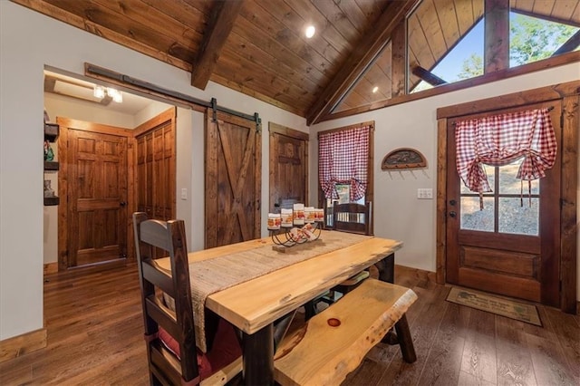 dining space featuring wood ceiling, a barn door, beam ceiling, and a healthy amount of sunlight