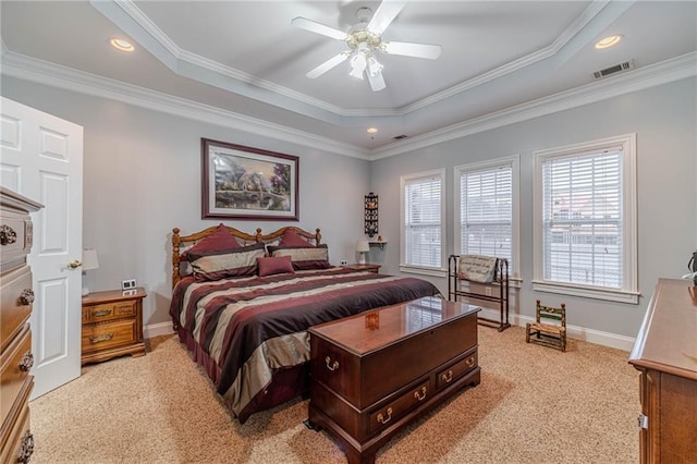 carpeted bedroom featuring crown molding, ceiling fan, and a tray ceiling