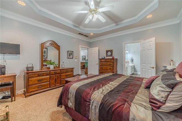 bedroom featuring ensuite bathroom, crown molding, carpet flooring, a raised ceiling, and ceiling fan