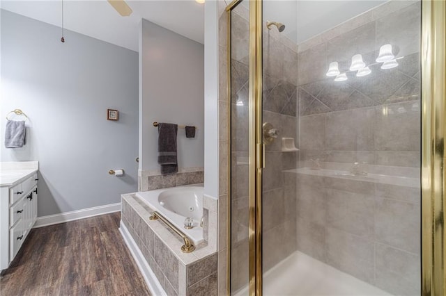 bathroom featuring vanity, ceiling fan, hardwood / wood-style flooring, and separate shower and tub