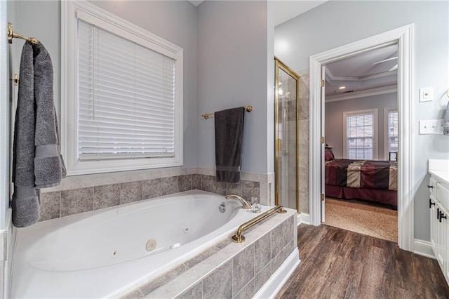 bathroom with vanity, hardwood / wood-style floors, ornamental molding, and plus walk in shower