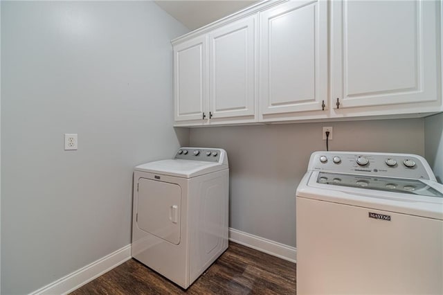 clothes washing area with cabinets, dark hardwood / wood-style floors, and washer and clothes dryer