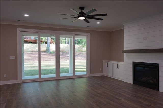unfurnished living room featuring crown molding, a ceiling fan, a fireplace, and dark wood-type flooring