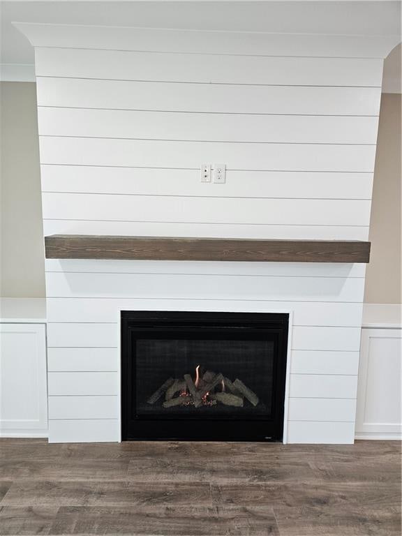 details with a fireplace and wood finished floors