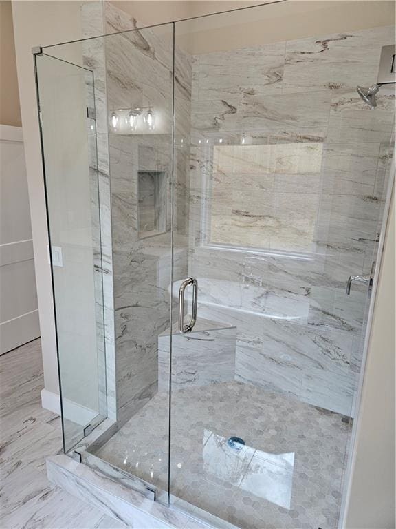 full bathroom with a marble finish shower