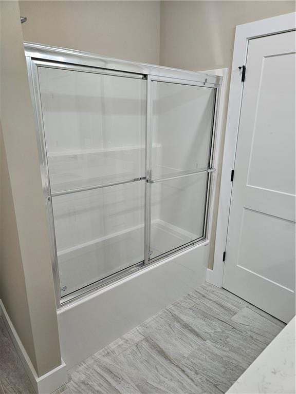 full bathroom with enclosed tub / shower combo