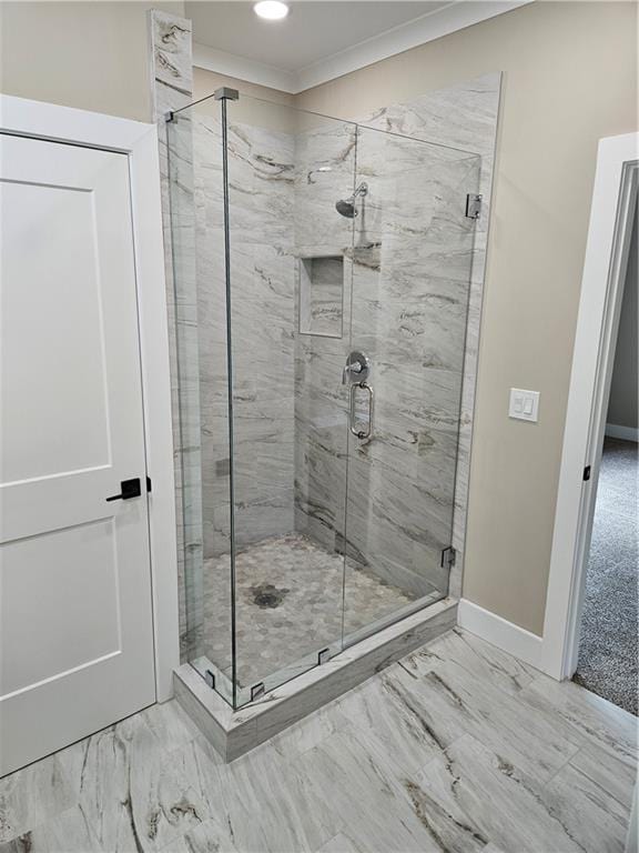 full bath with baseboards, a shower stall, and marble finish floor