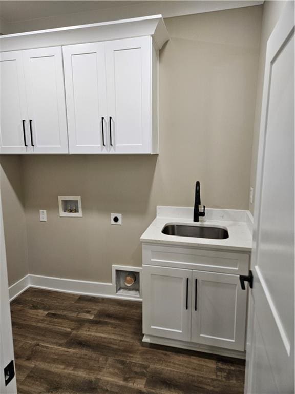 washroom featuring a sink, dark wood-style flooring, cabinet space, electric dryer hookup, and hookup for a washing machine