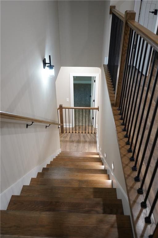 stairway featuring wood finished floors