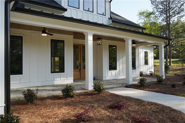 doorway to property featuring board and batten siding, a porch, and a ceiling fan