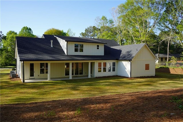 back of house featuring a patio area, central air condition unit, a yard, and roof with shingles