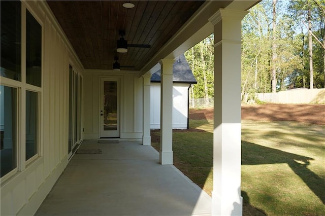view of patio / terrace with ceiling fan and fence