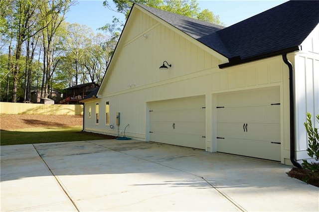 garage featuring concrete driveway