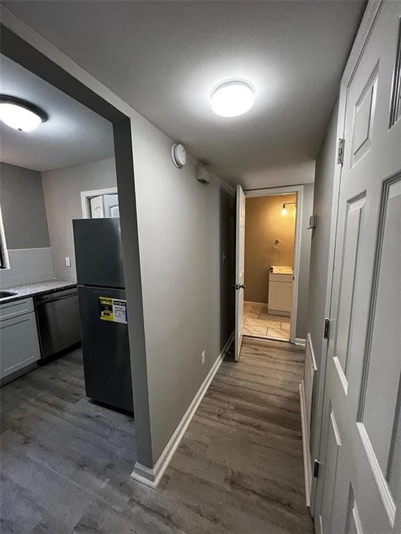 3932 Darryl Ln, Gainesville, GA 30506 - corridor with washer / clothes dryer, baseboards, and dark wood-style flooring
