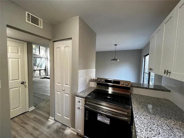 3932 Darryl Ln, Gainesville, GA 30506 - kitchen with electric range, plenty of natural light, visible vents, and white cabinetry