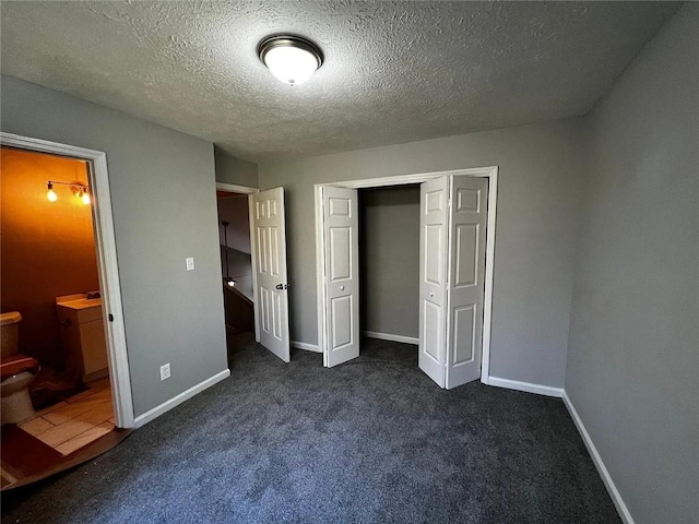 3932 Darryl Ln, Gainesville, GA 30506 - unfurnished bedroom with a closet, dark carpet, ensuite bath, and baseboards