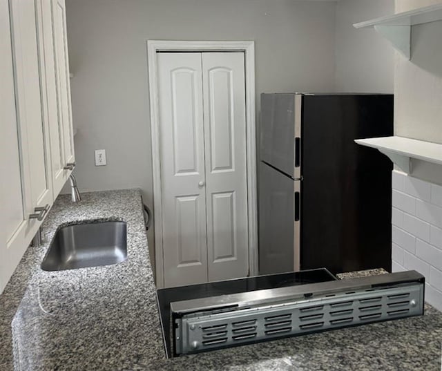 3932 Darryl Ln, Gainesville, GA 30506 - kitchen with a sink, dark stone countertops, and freestanding refrigerator