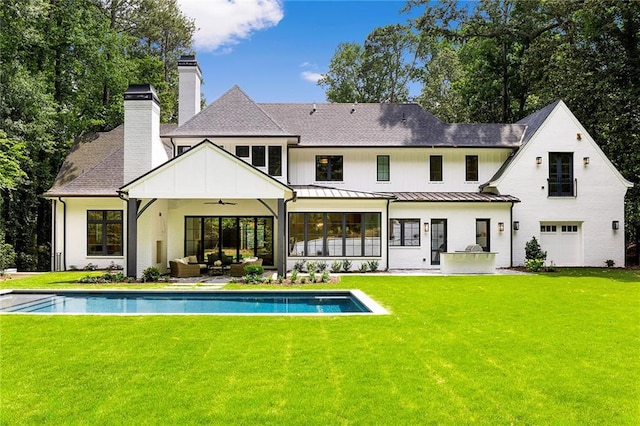 rear view of house featuring a patio, a lawn, and ceiling fan