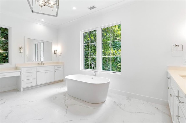 bathroom featuring vanity, ornamental molding, and a bathing tub