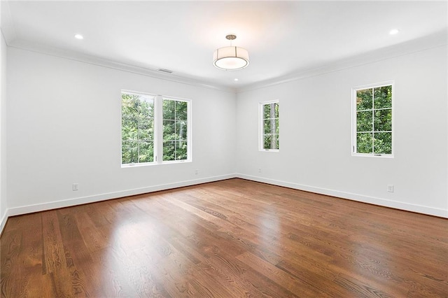 unfurnished room featuring ornamental molding and hardwood / wood-style floors