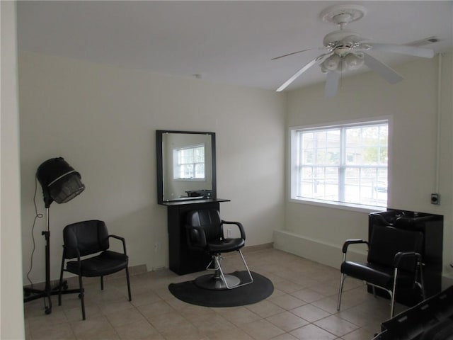 living area featuring ceiling fan and light tile patterned floors