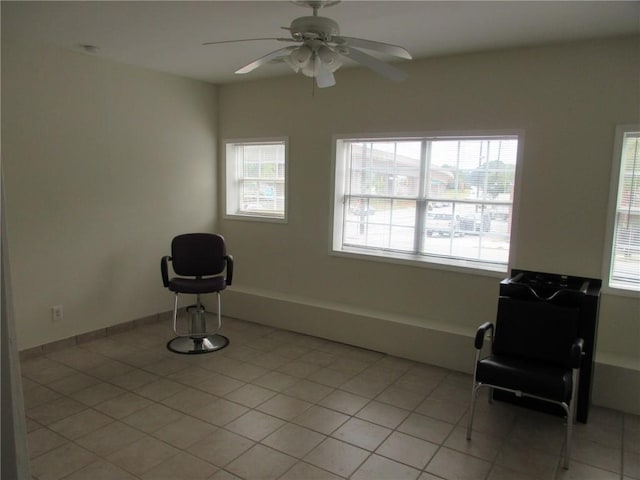 unfurnished room with light tile patterned floors and ceiling fan