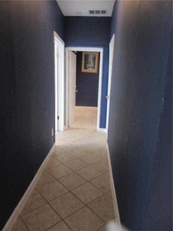 corridor featuring light tile patterned floors