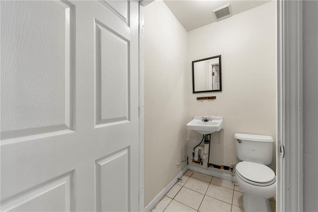 bathroom featuring sink, tile patterned floors, and toilet