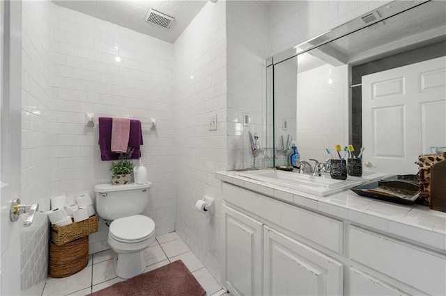 bathroom with radiator, tile walls, tile patterned flooring, vanity, and toilet